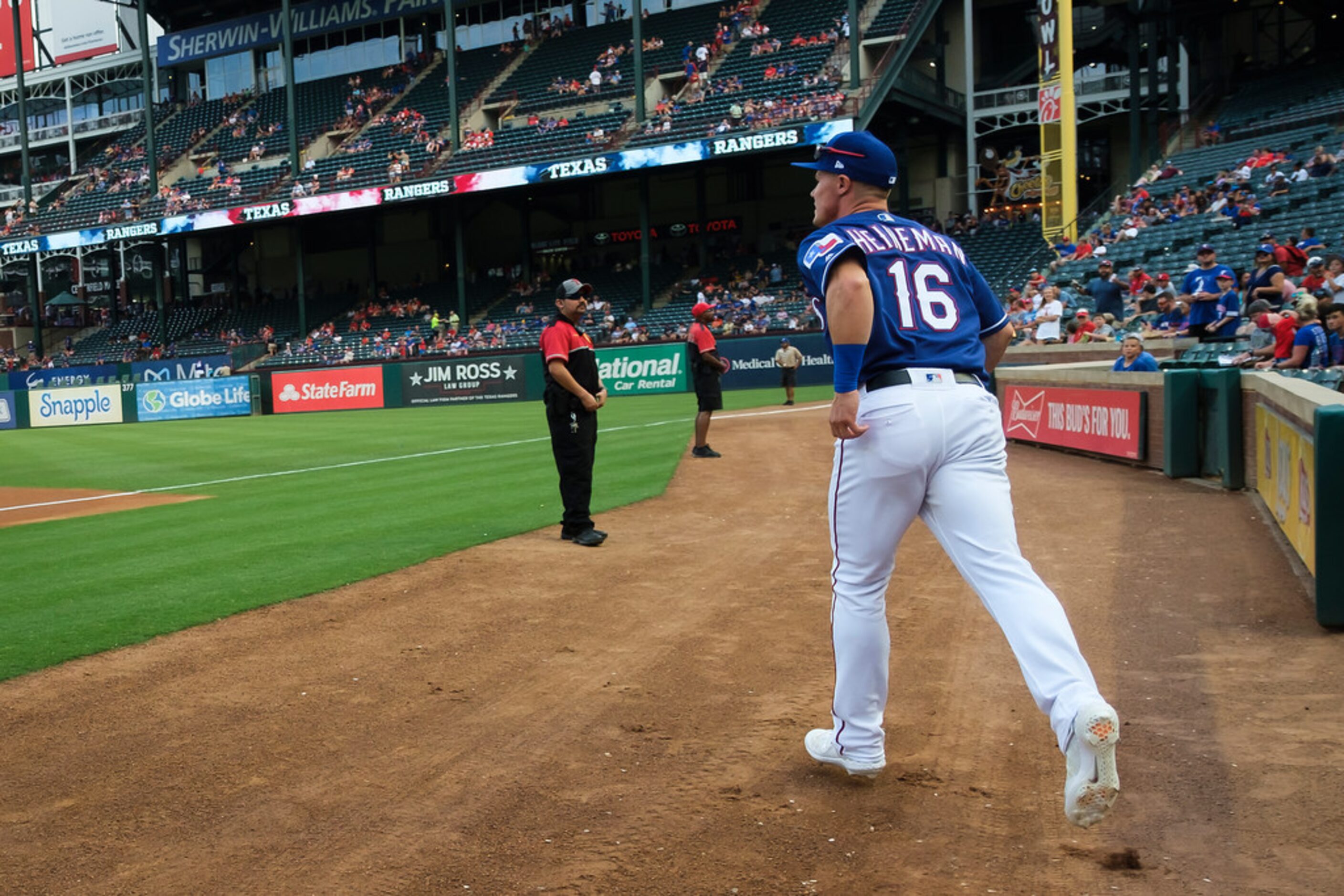 Texas Rangers outfielder Scott Heineman takes the field to warm up before a game against the...