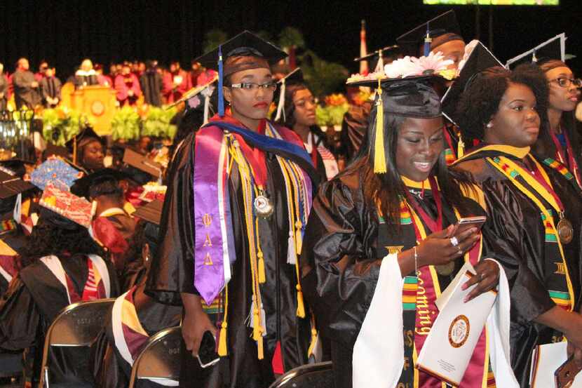 Some Bethune-Cookman University graduates, seen at left, turn their backs as U.S. Secretary...