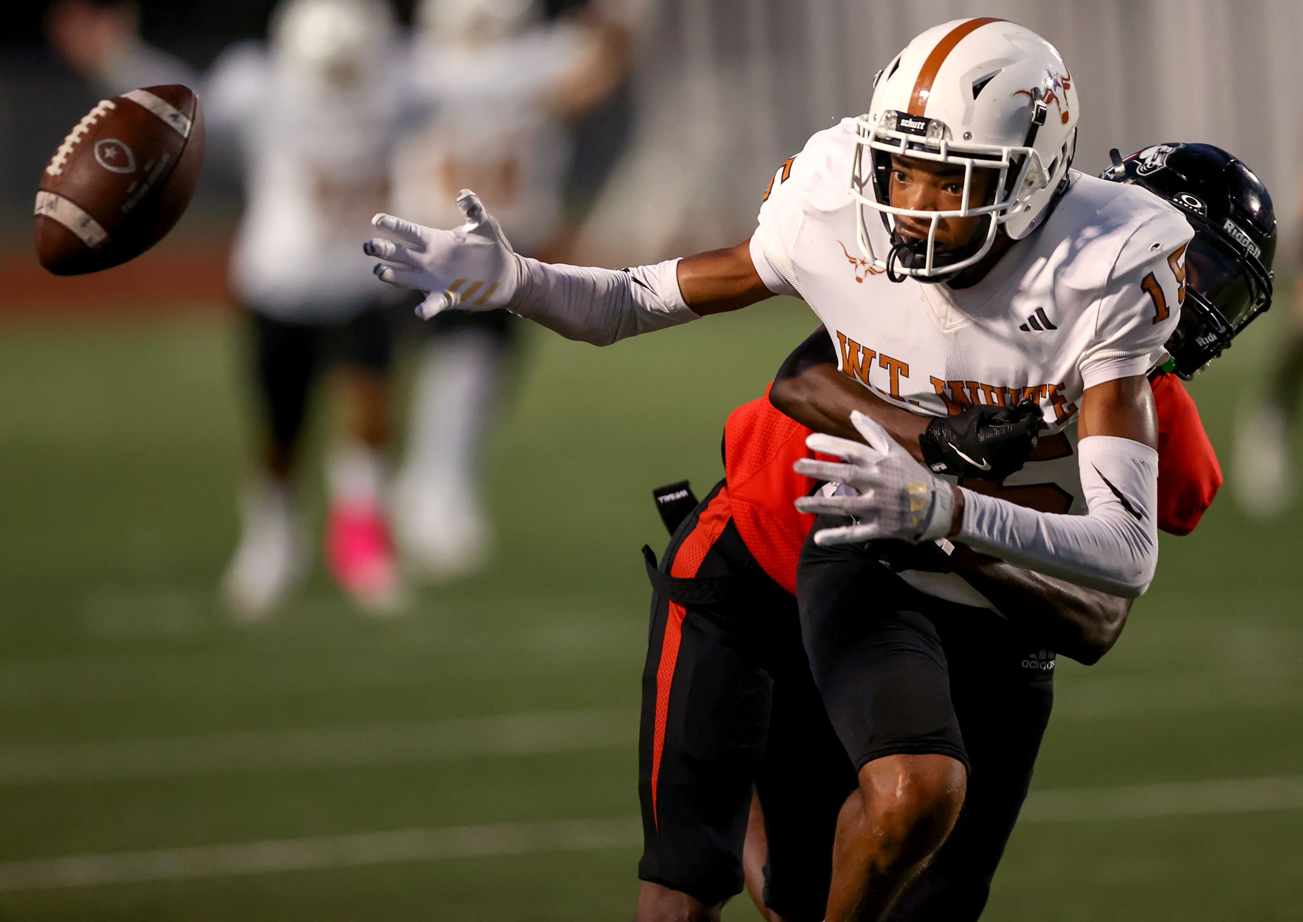 W.T. White wide receiver Lovell Neal (15) gets stripped of the ball by Creekview defensive...