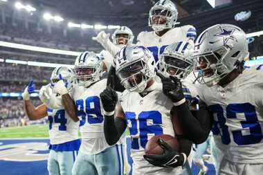 Dallas Cowboys cornerback DaRon Bland (26) celebrates with teammates after intercepting a...