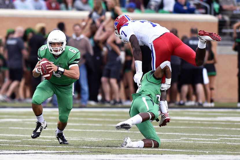 North Texas freshman quarterback Mason Fine (6) scrambles in the pocket as Louisiana Tech...