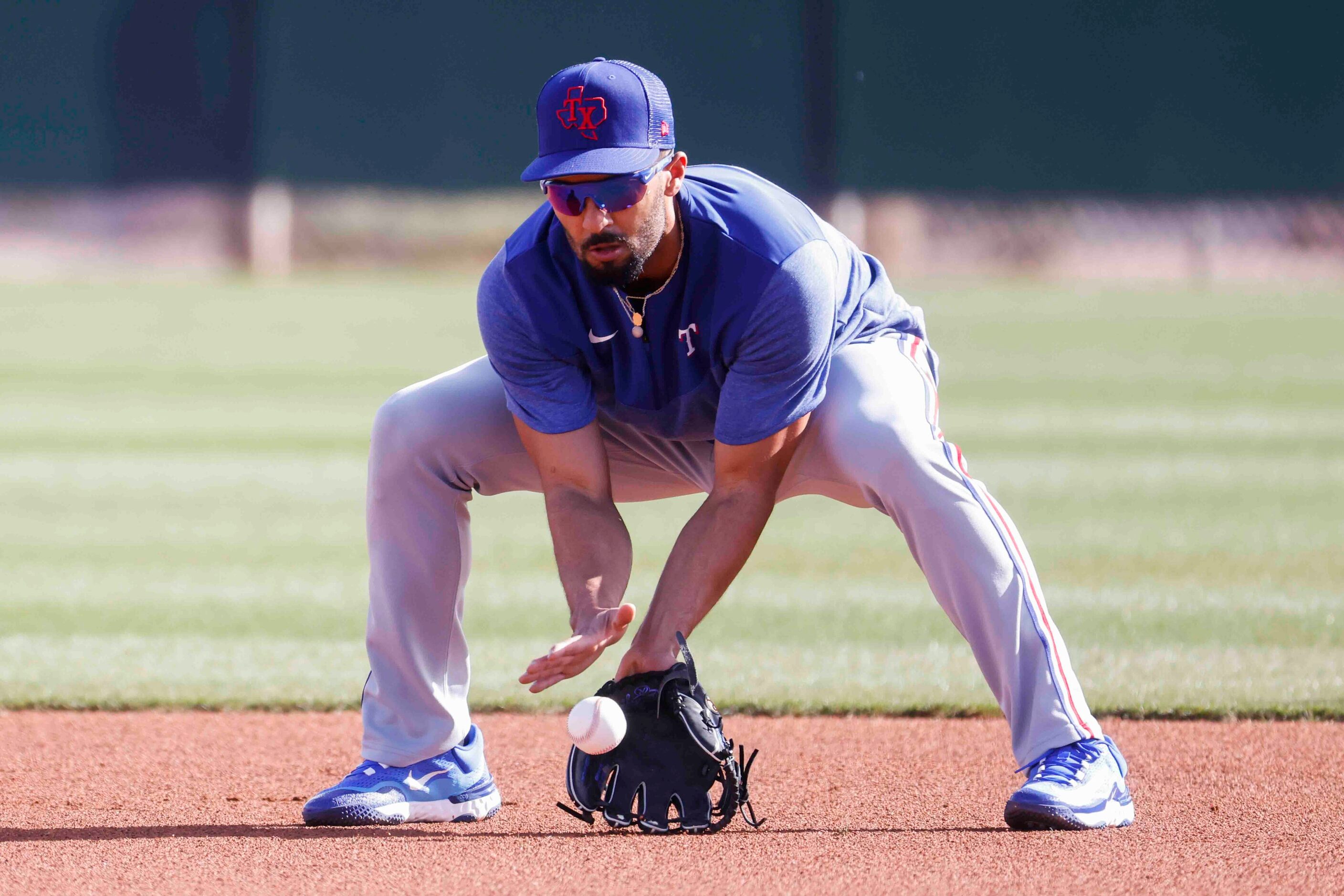 Texas Rangers second baseman Marcus Semien takes part in fielding drill during a spring...