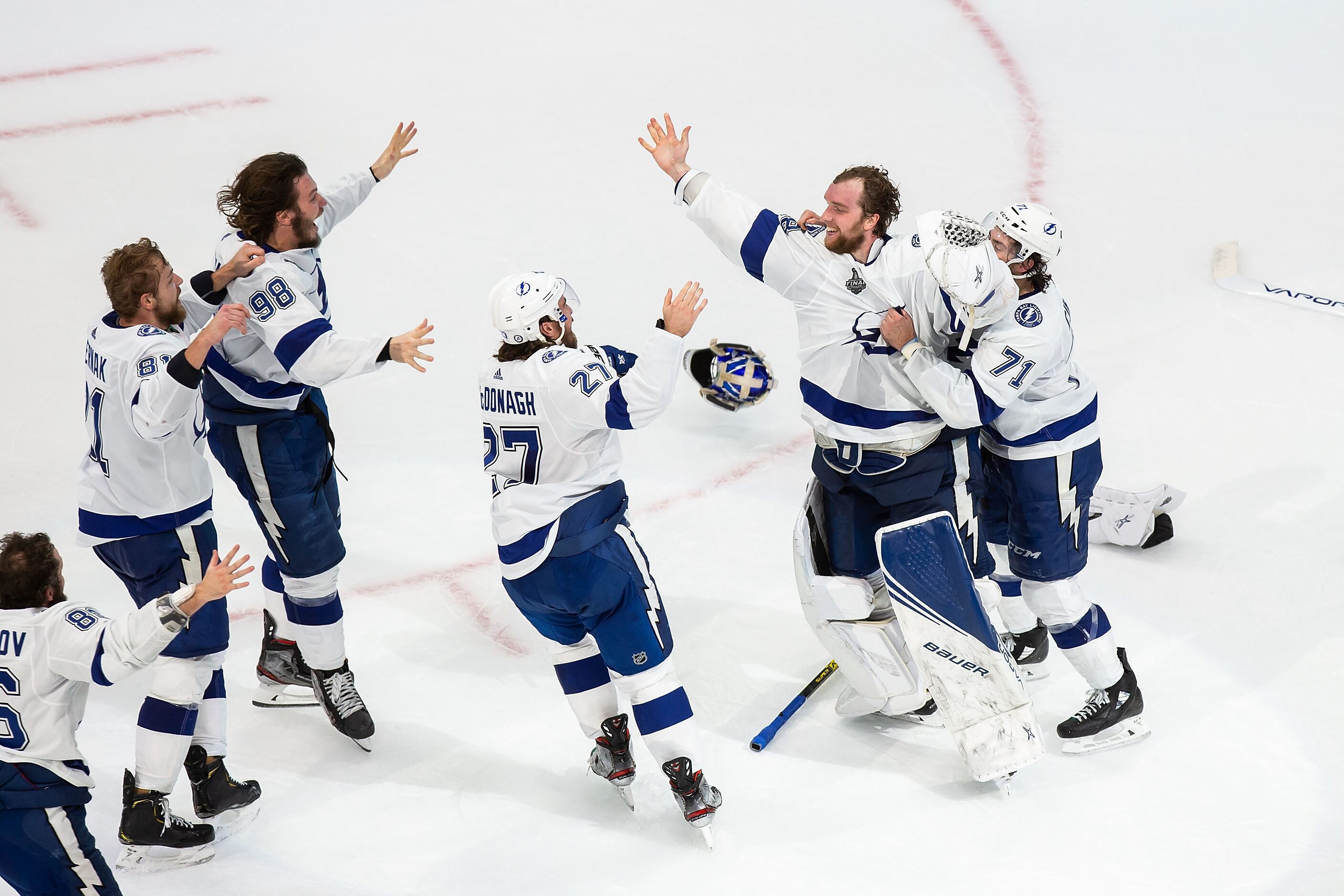 The Tampa Bay Lightning react with goaltender Andrei Vasilevskiy (88) to their victory...