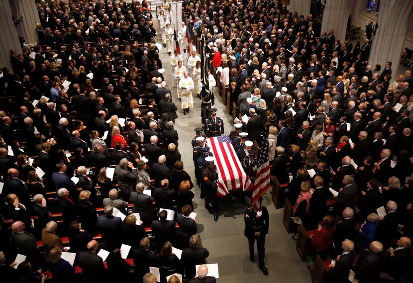 Military pallbearers carry the casket of George H.W. Bush, the 41st President of the United...