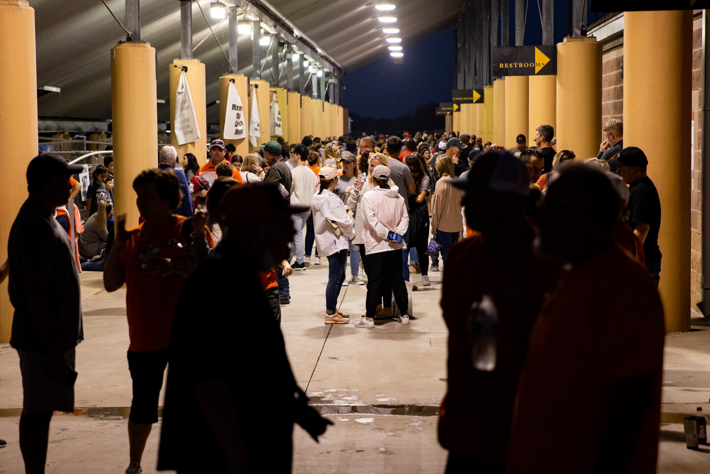 Fans hide from the storm during the weather delay before the Celina against Palestine boys...