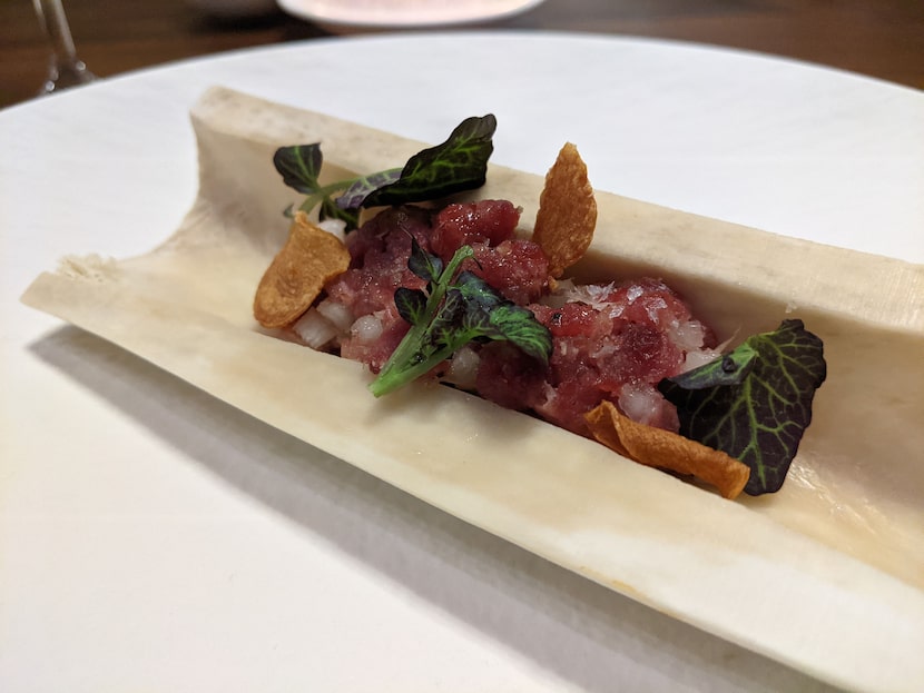 Elk tartare and garlic chips, served on an elk bone at Carte Blanche.