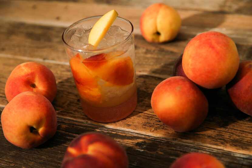 A peach cocktail with rum and ginger is seen Wednesday, July 10, 2019 in The Dallas Morning...