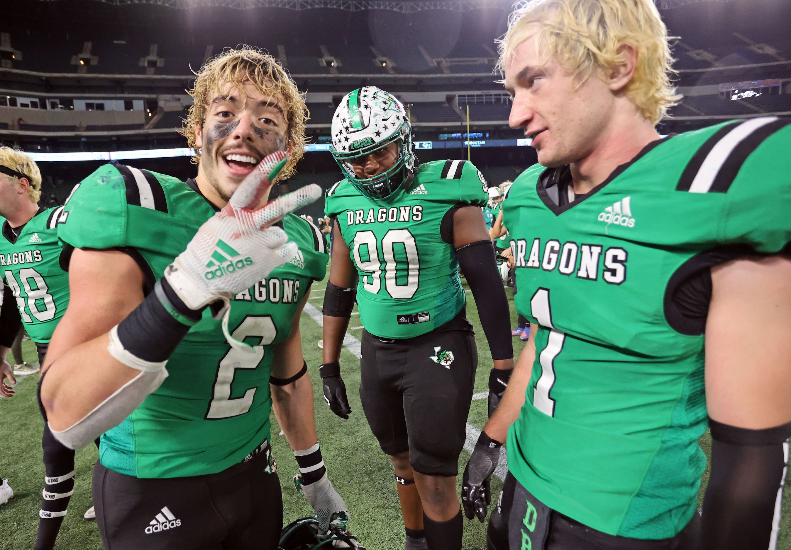 Southlake’s Owen Allen (2) celebrates with teammates, Kyle Middleton (90) and Logan Anderson...