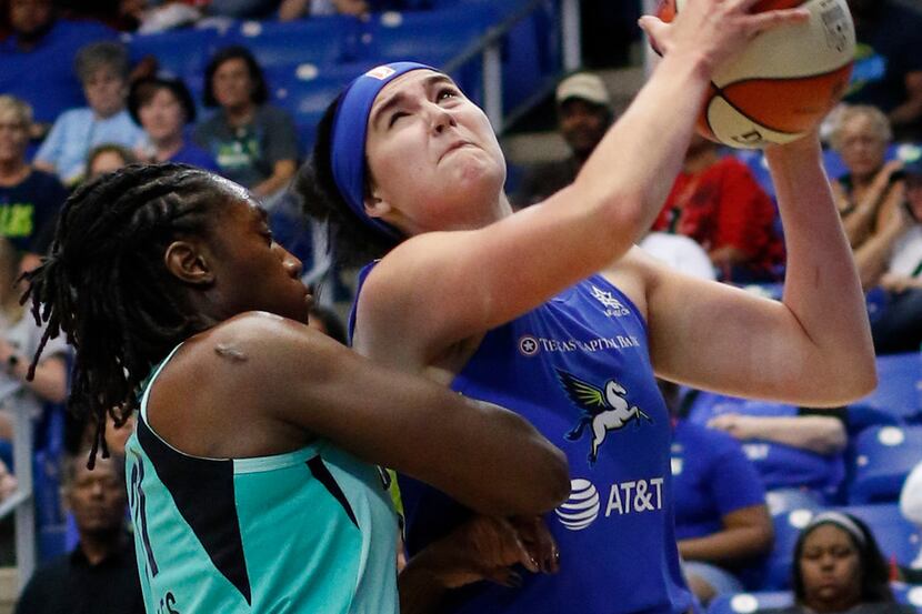 Dallas Wings forward Megan Gustafson (13) drives to the basket past the defense of New York...