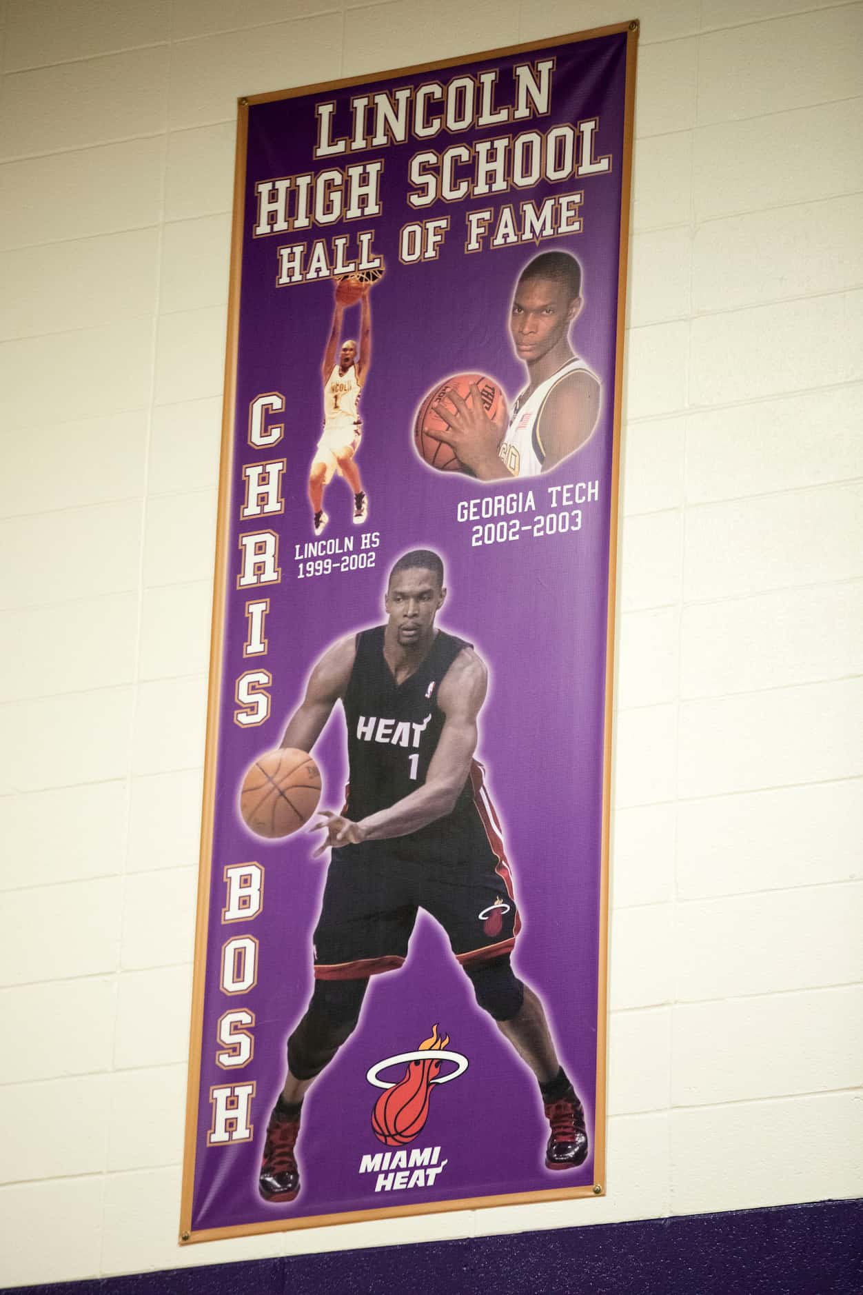 A Lincoln High School banner is shown in the gym recognizing the accomplishments of alumni,...
