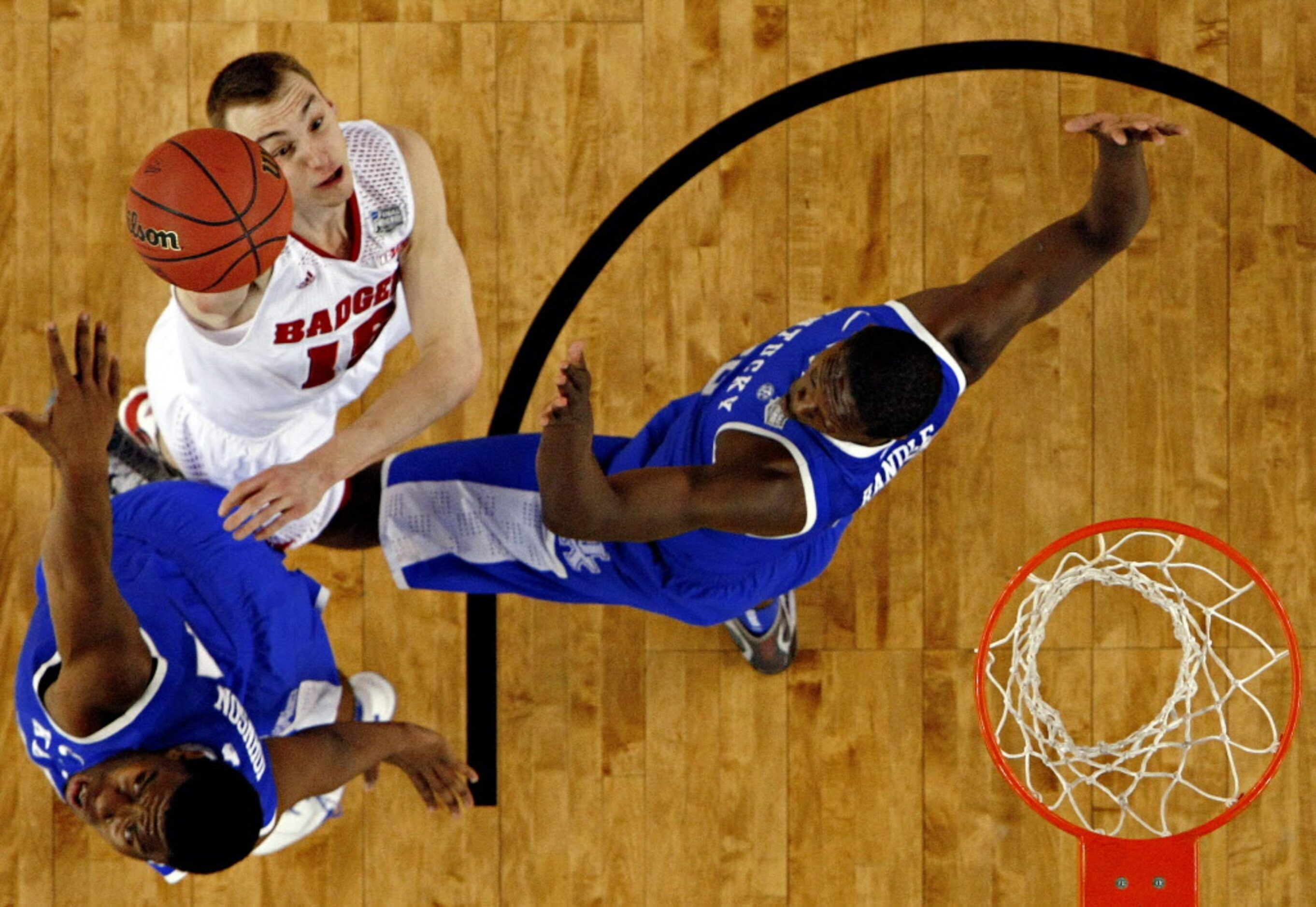 Wisconsin Badgers forward Sam Dekker (15) goes up against Kentucky Wildcats center Dakari...