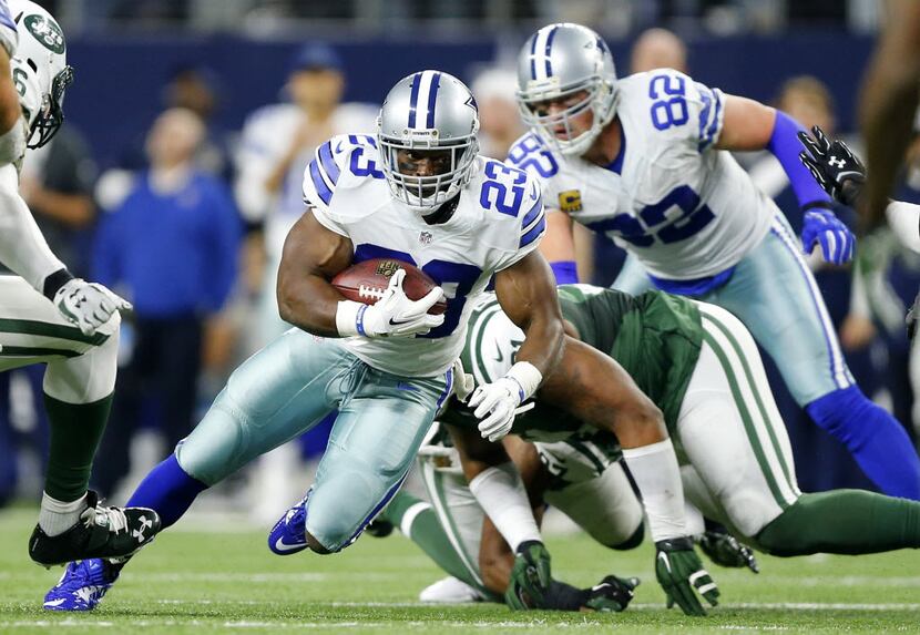 Dallas Cowboys running back Robert Turbin (23) cuts back against the New York Jets defense...