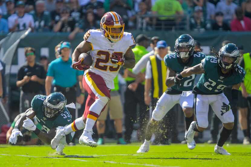 Washington Redskins running back Derrius Guice (29) looks for running room during Sunday's...