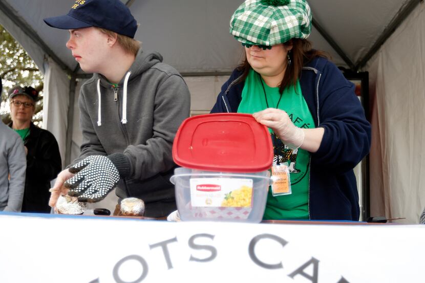Scots Café student Luke Andrews, left, and Kerry Fergason prepare a baked potato for a...