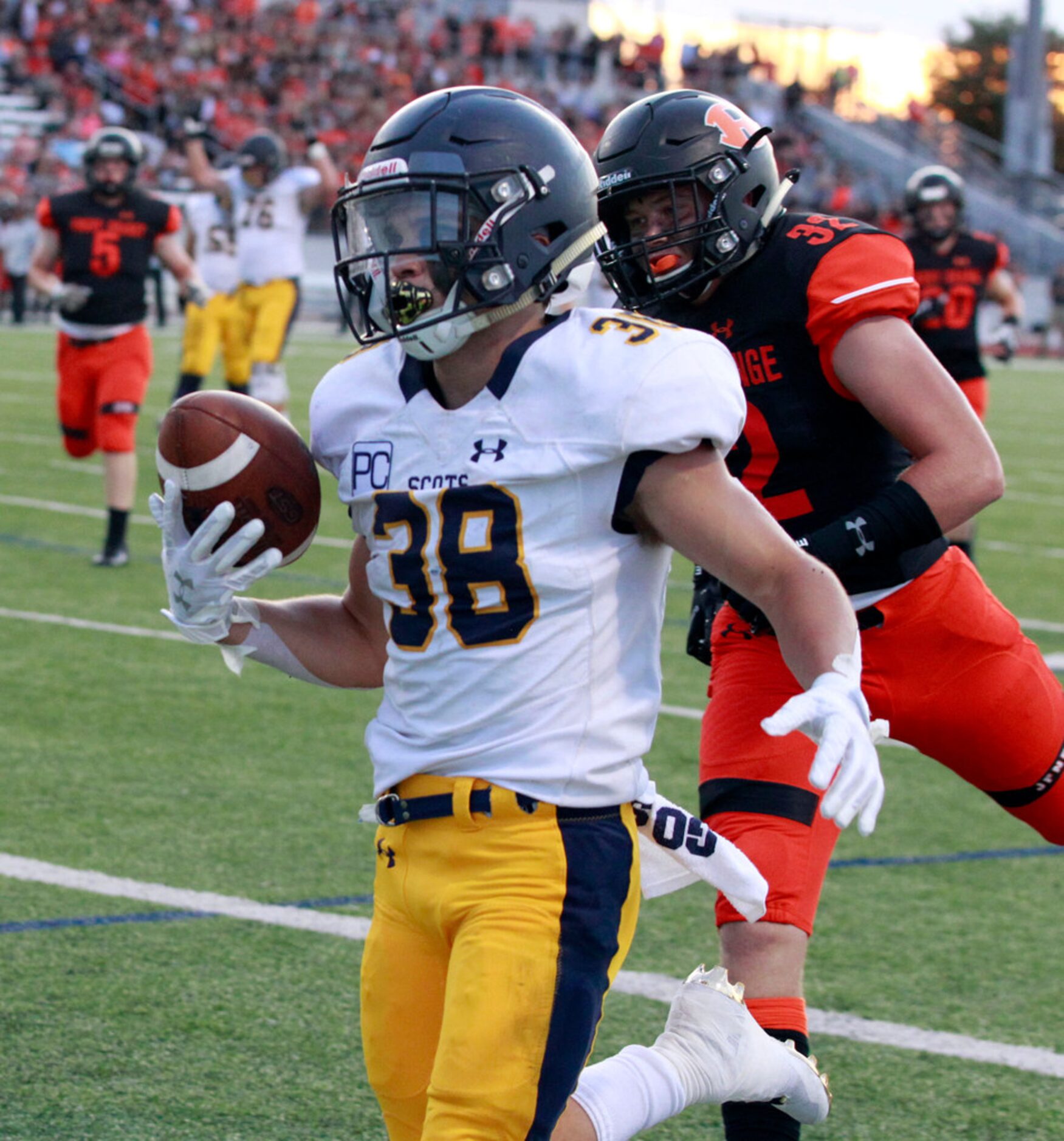 Highland Park's Hunter Heath (38) beats Rockwall defender Joseph Schaefer (32) to the end...