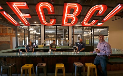 Co-owner Greg Leftwich (right) gets a glass of beer inside the taproom at the new Four...