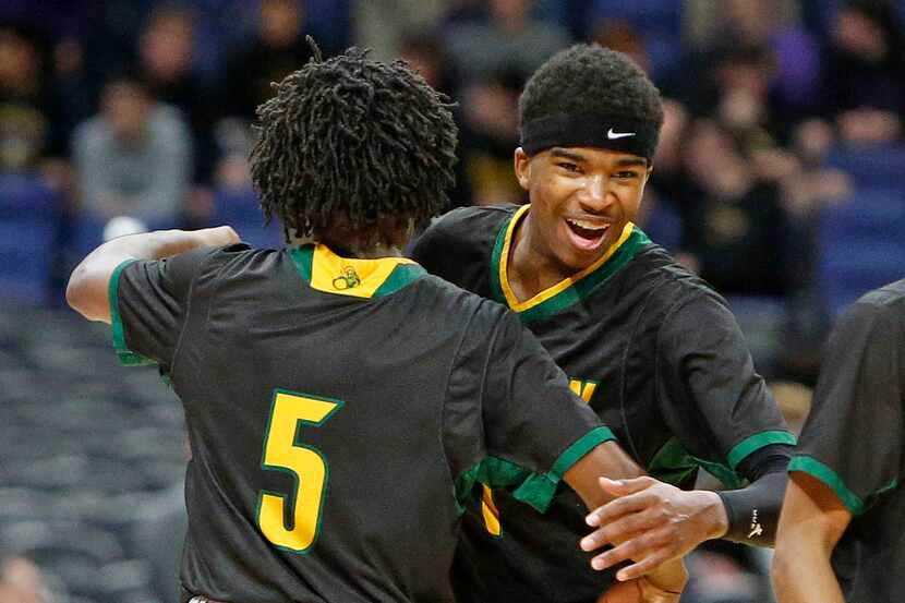 Madison's Dominique Robinson #1 gets a hug from  Madison's Dyeshun King #5 at the end of the...