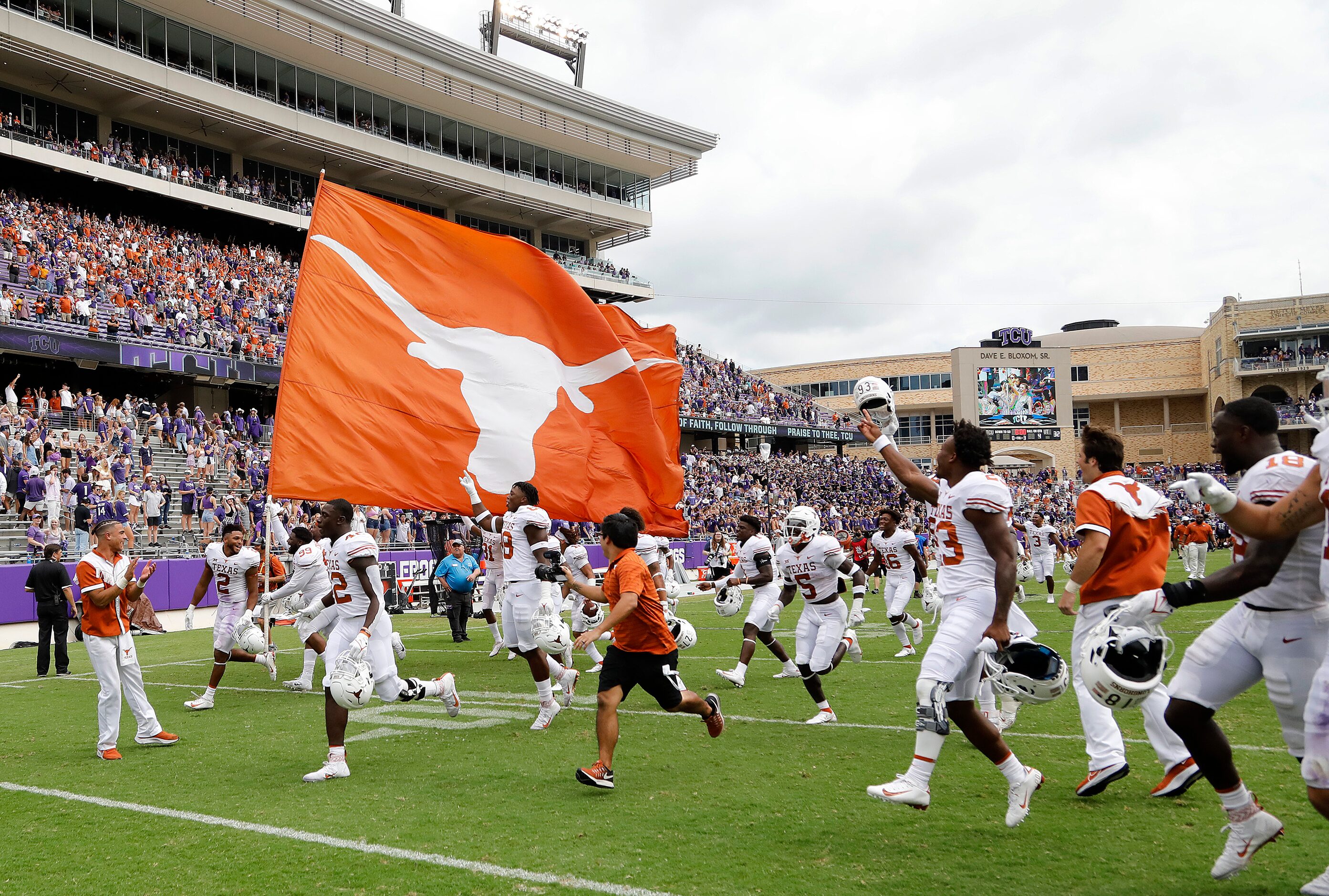 The Texas Longhorns take the field with a spirit flag after their victory as the TCU Horned...