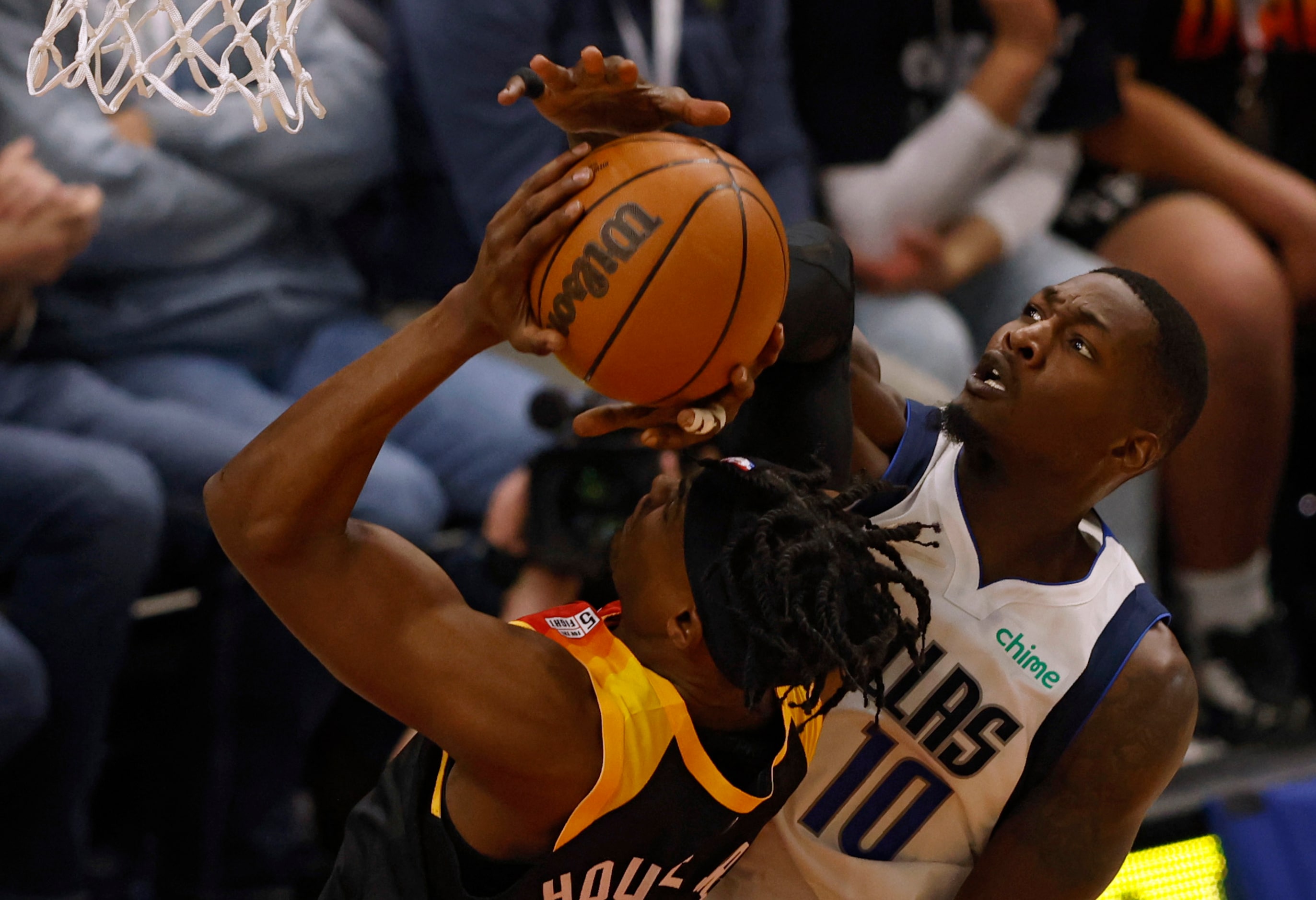 Dallas Mavericks forward Dorian Finney-Smith (10) fouls as Utah Jazz forward Danuel House...