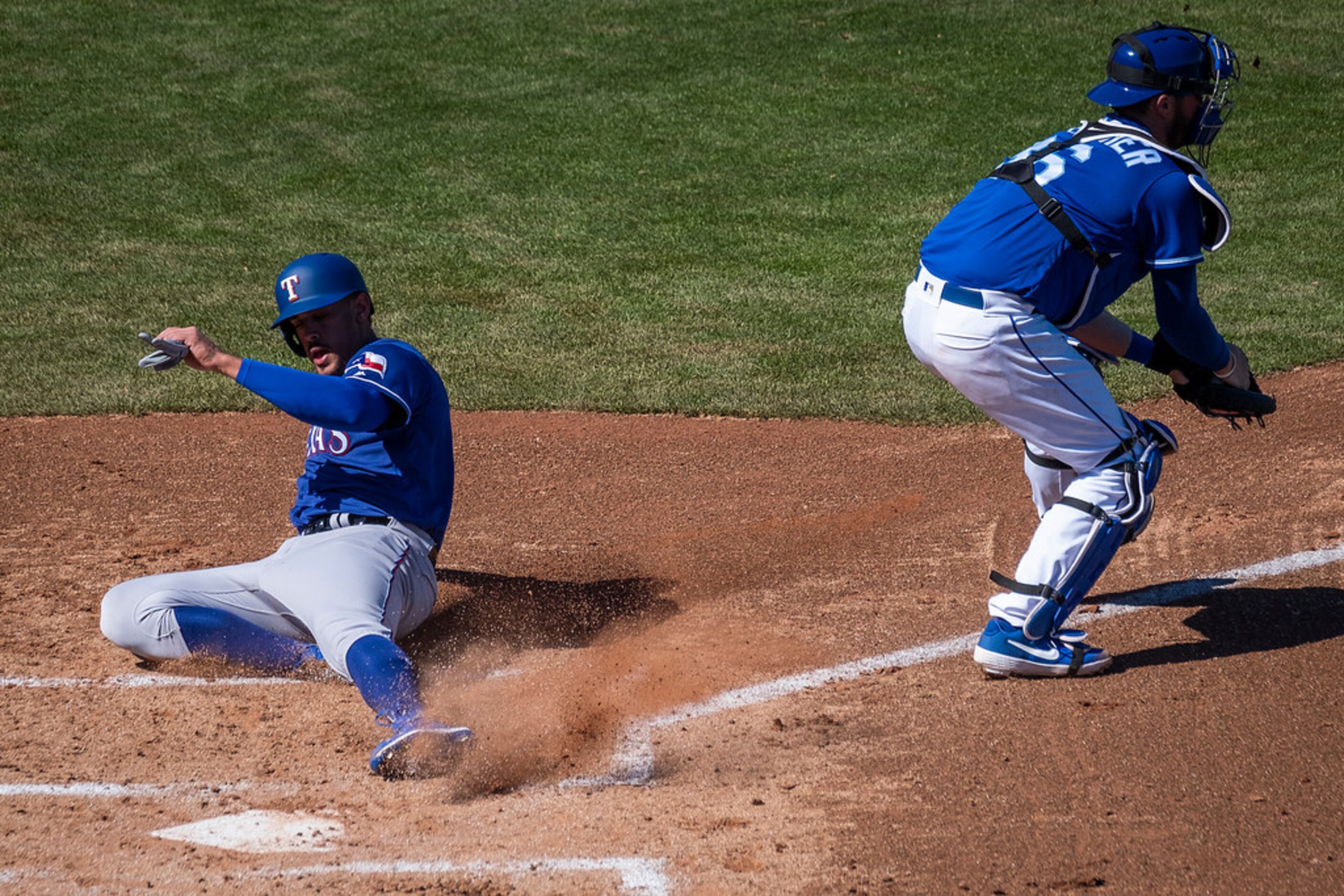 Texas Rangers first baseman Ronald Guzmâ¡n scores the Rangers lone run of the game past...