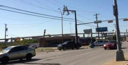  Both the silver and the black truck collided before the silver truck struck the pole.