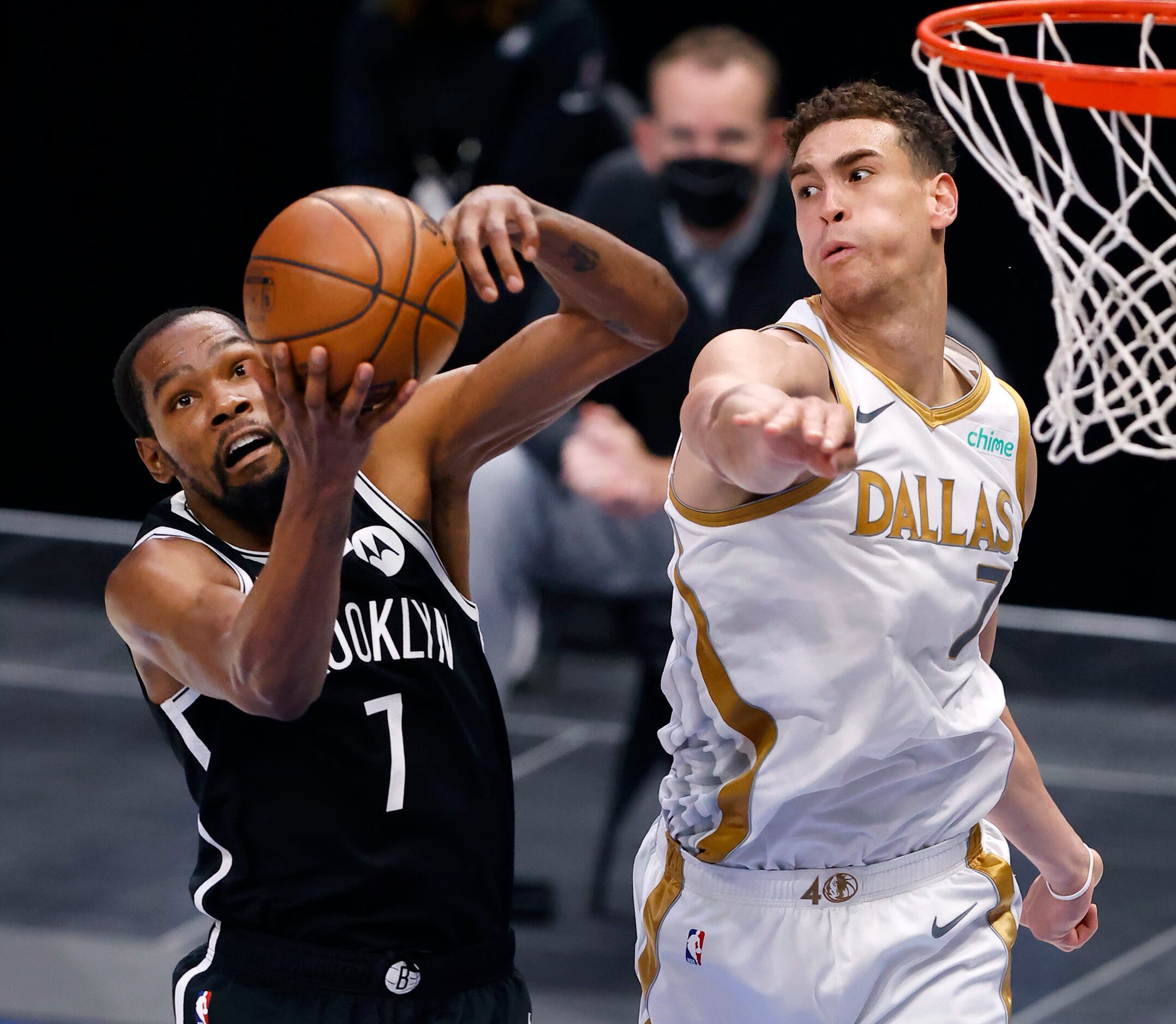 Dallas Mavericks center Dwight Powell (7) tries to swat away a rebound by Brooklyn Nets...