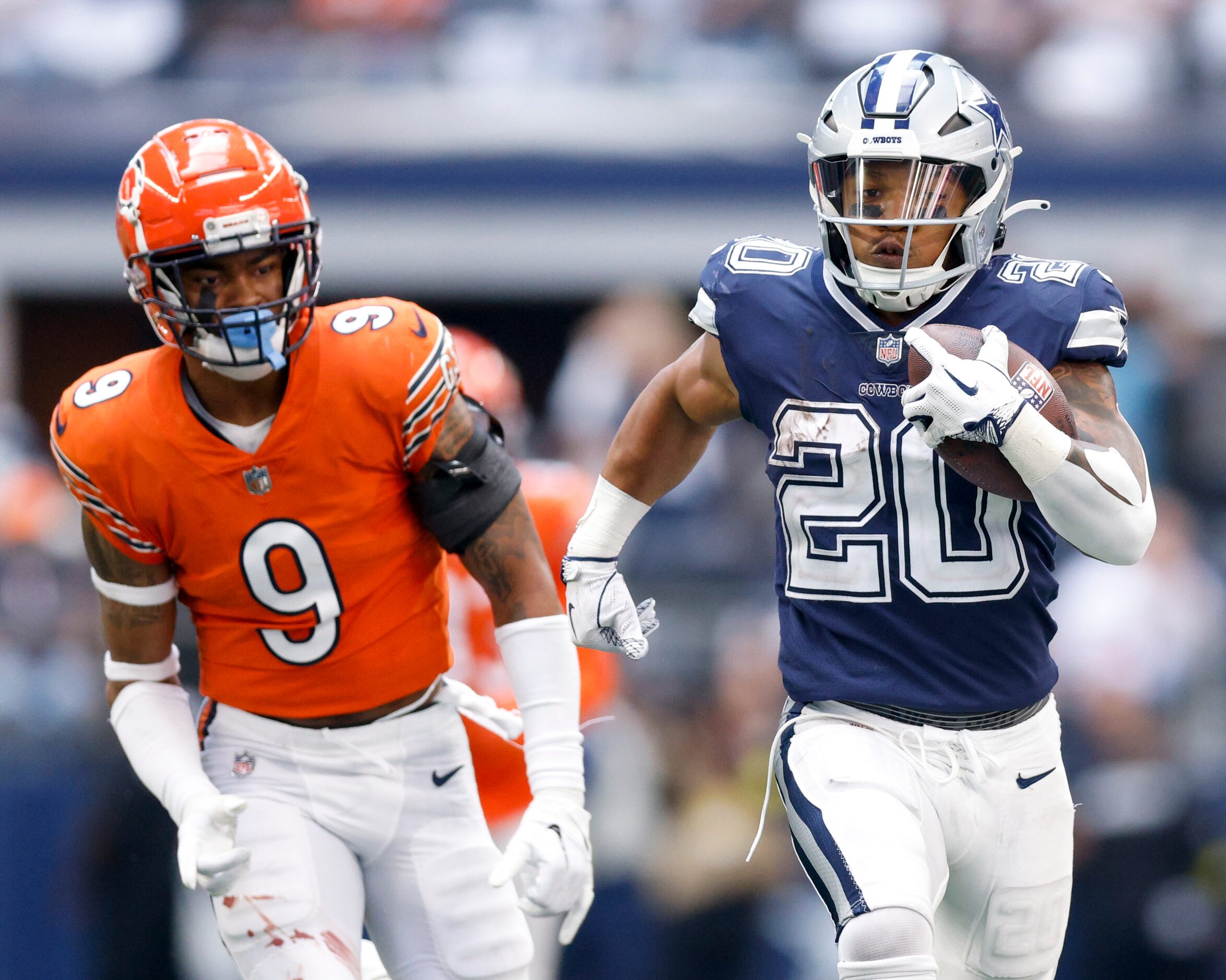 Dallas Cowboys running back Tony Pollard (20) races past Chicago Bears safety Jaquan Brisker...