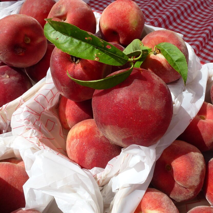 At White Rock Local Market, shoppers wait in line for the first peaches of the season from...