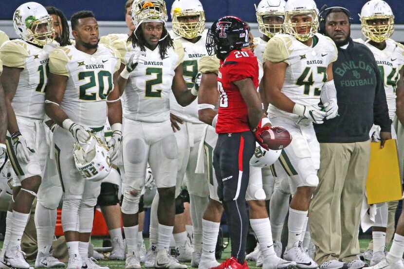 Texas Tech receiver Keke Coutee (20) gets the strs-down from a group of Baylor players after...