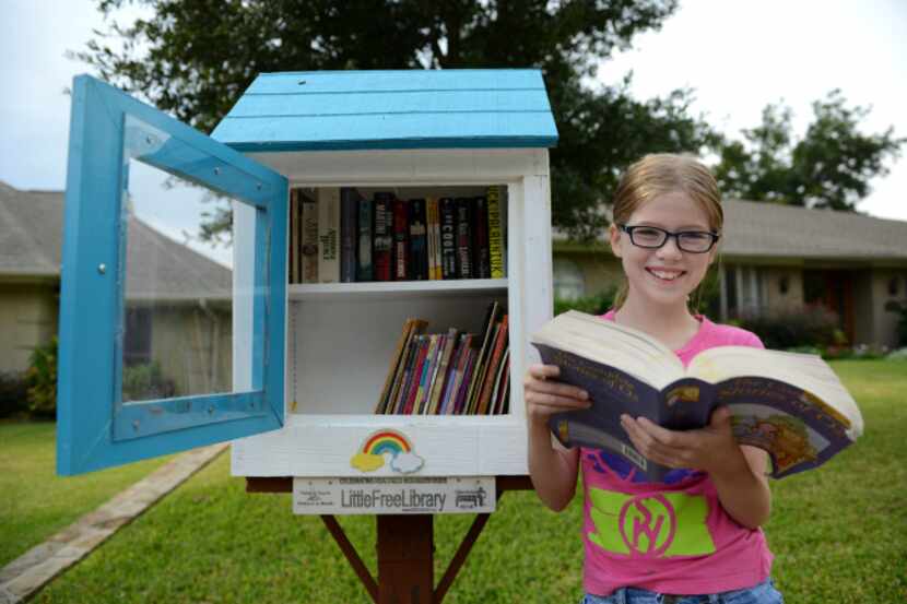 Hannah Wahl, 11, is the steward of a Little Free Library at 6434 Malcolm Drive in Lakewood....