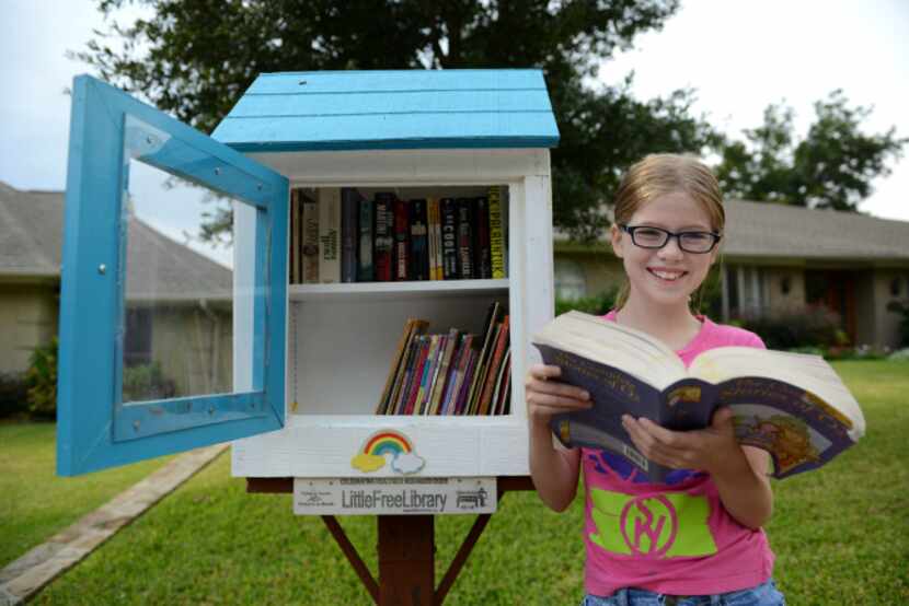 Hannah Wahl, 11, is the steward of a Little Free Library at 6434 Malcolm Drive in Lakewood....