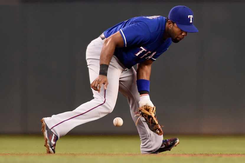 MINNEAPOLIS, MN - AUGUST 12: Elvis Andrus #1 of the Texas Rangers is unable to field a ball...