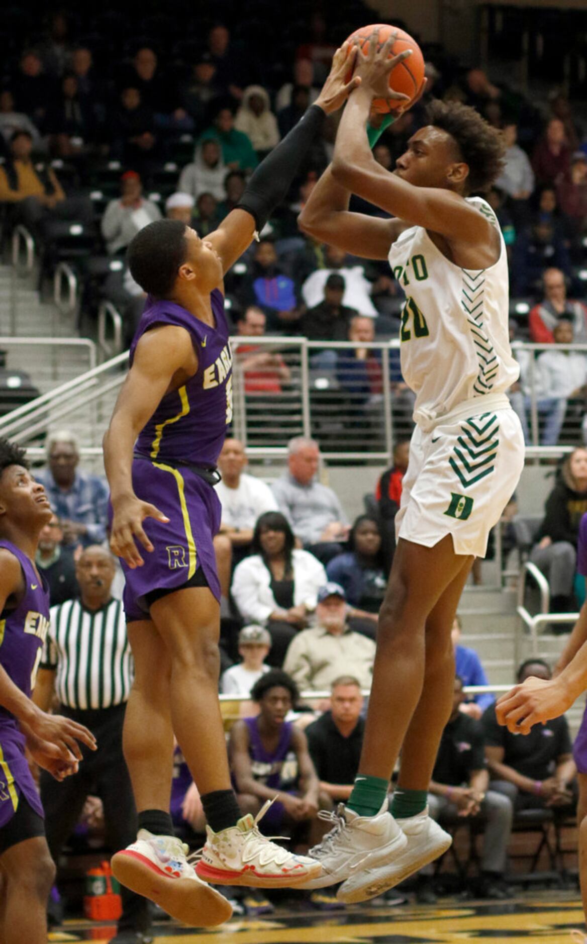 DeSoto's Christen Morgan (20) shoots a jump shot as he is defended by Richardson's Tre...