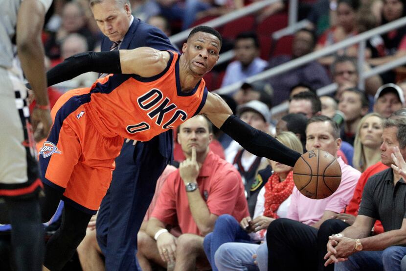 Oklahoma City Thunder point guard Russell Westbrook (0) dives to keep the ball inbound...