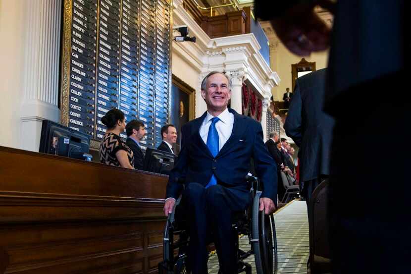 Texas Governor Greg Abbott makes his way out of the Texas House of Representatives after...