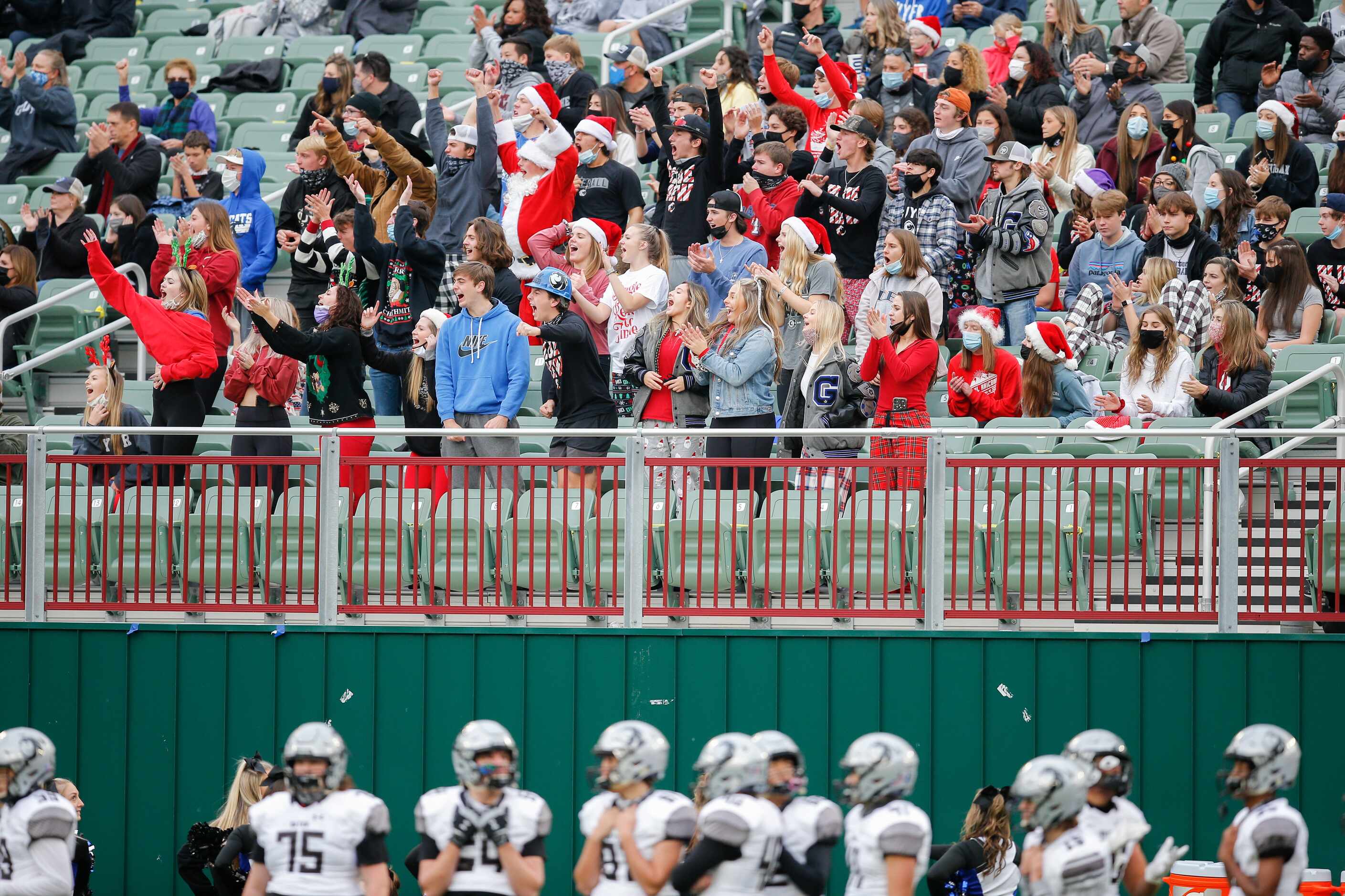 The Denton Guyer student section cheers on their team during the first half of a high school...