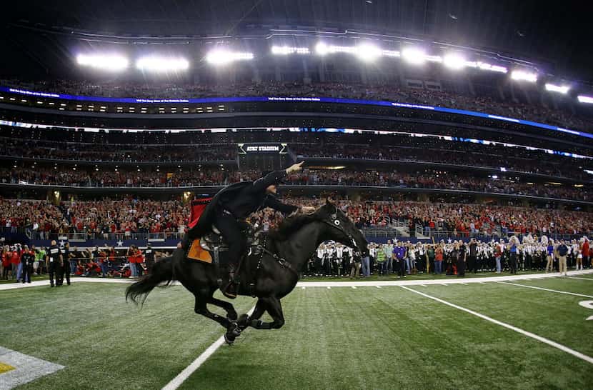 The Texas Tech Masked Rider leads the team onto the field to face the Baylor Bears at AT&T...