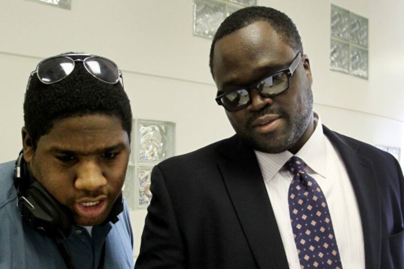 Comerica Bank senior vice president Irvin Ashford Jr. (right) talks with student Charles...