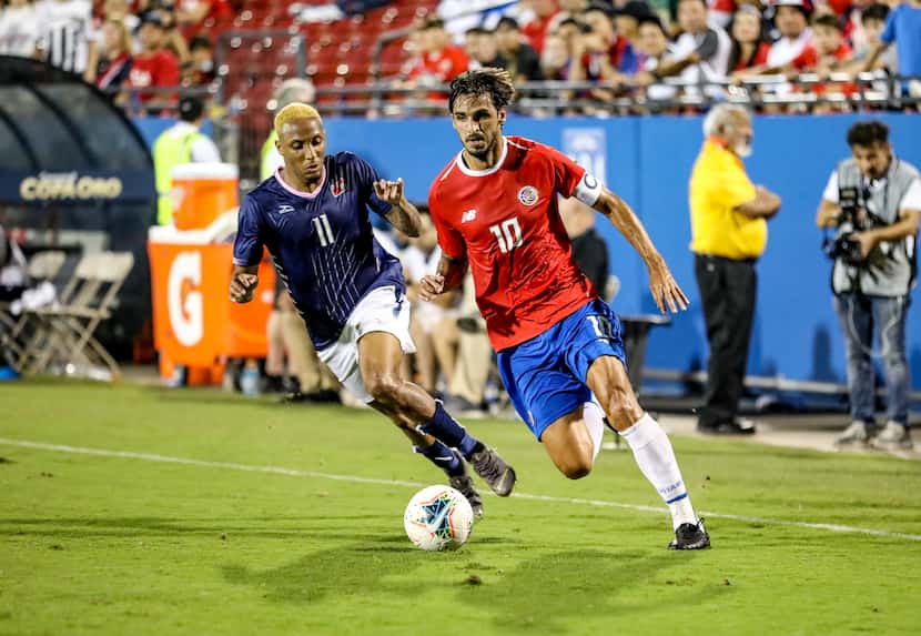 Bryan Ruiz of Costa Rica is chased by Bermuda's Willie Clemons during the 2019 Gold Cup at...