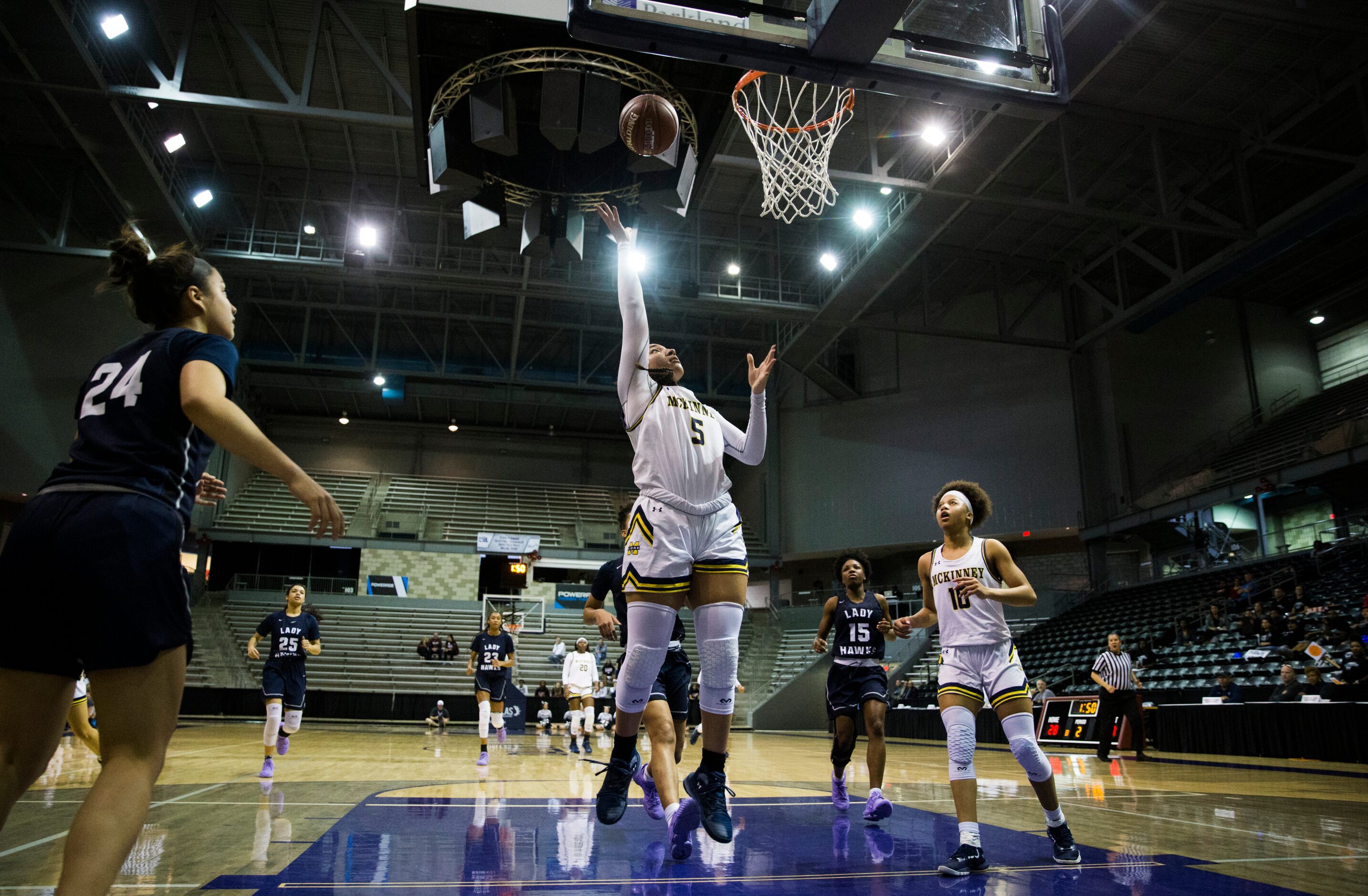 McKinney guard Trinity White (5) goes up for a shot during the first quarter of a UIL 6A...