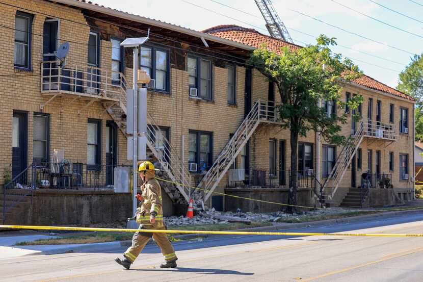 A Dallas Fire-Rescue firefighter crosses Matilda Street while responding to a partial...