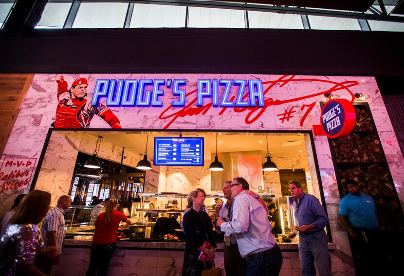 Guests enjoy Pudge's Pizza during the grand opening celebration for Texas Live! on Thursday,...