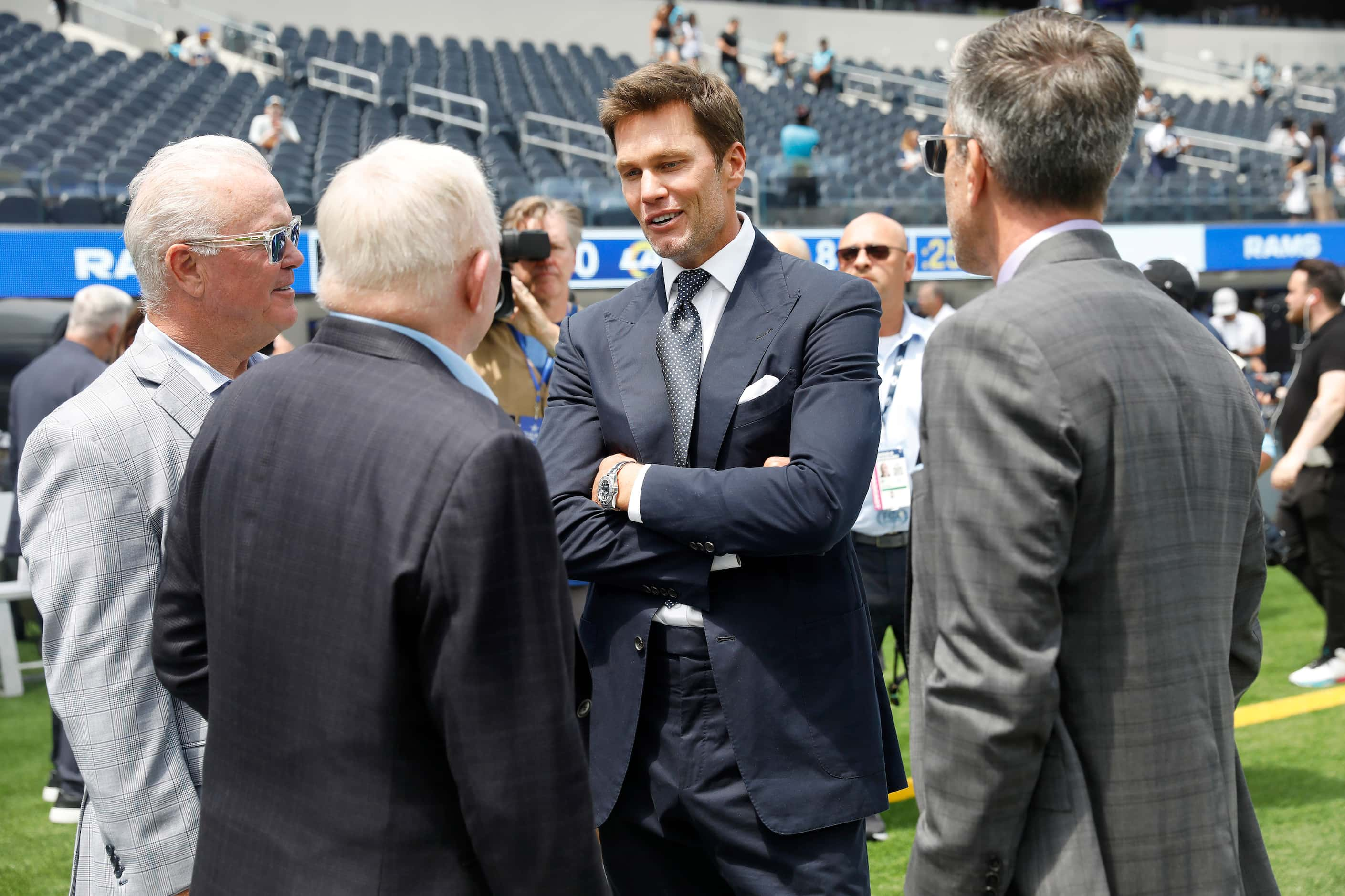 Dallas Cowboys owner Jerry Jones (second from left) and his son Stephen Jones (left) visit...