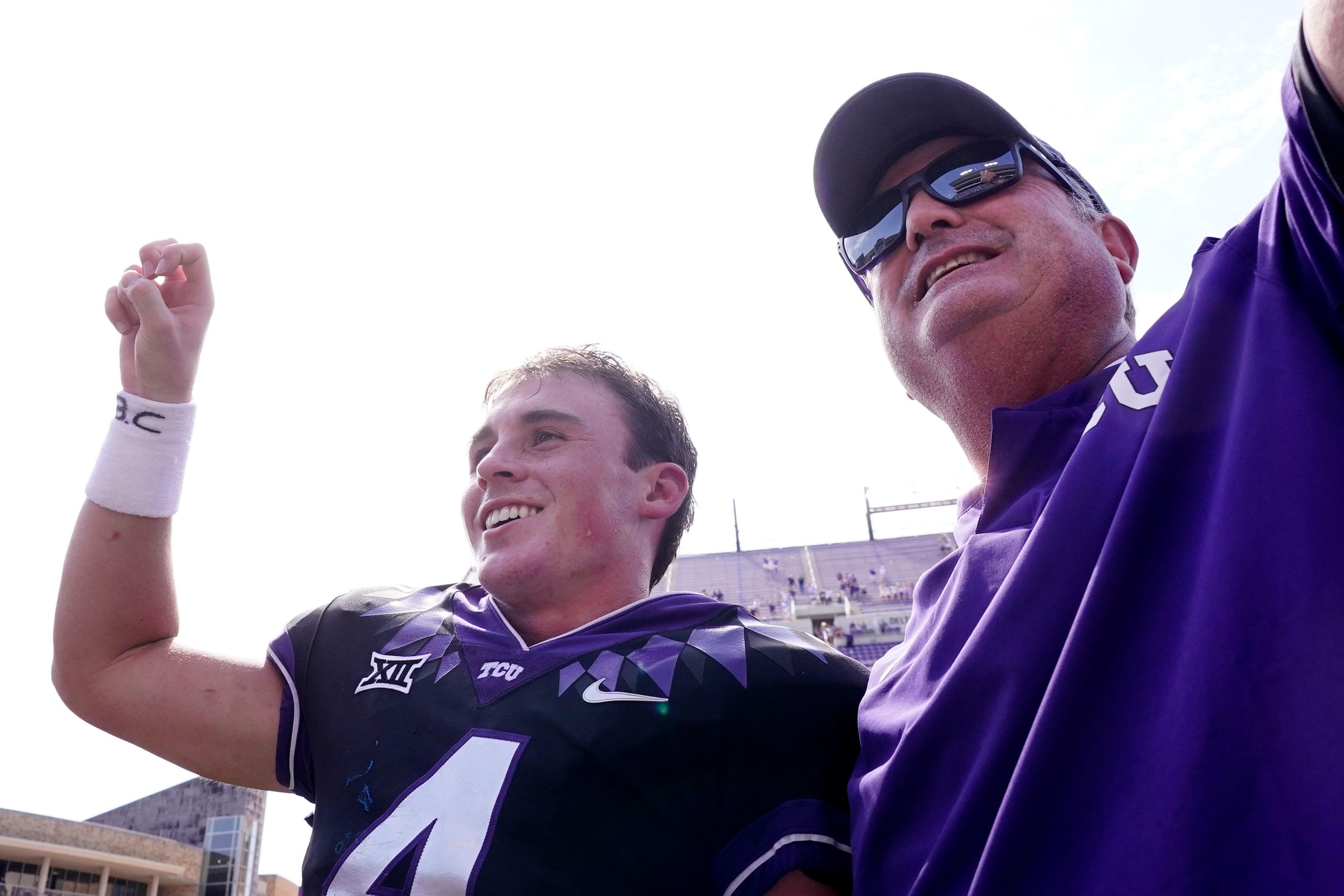 TCU quarterback Chandler Morris, left, smiles with head coach Sonny Dykes as their school...