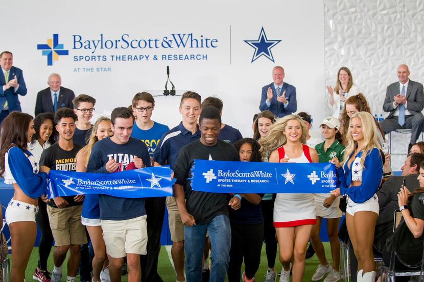 Frisco ISD students bust through a ribbon marking the official opening of Baylor Scott &...