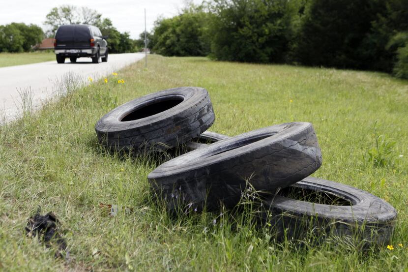 Old tires lay scattered on the side of Gooch Street in South Dallas.