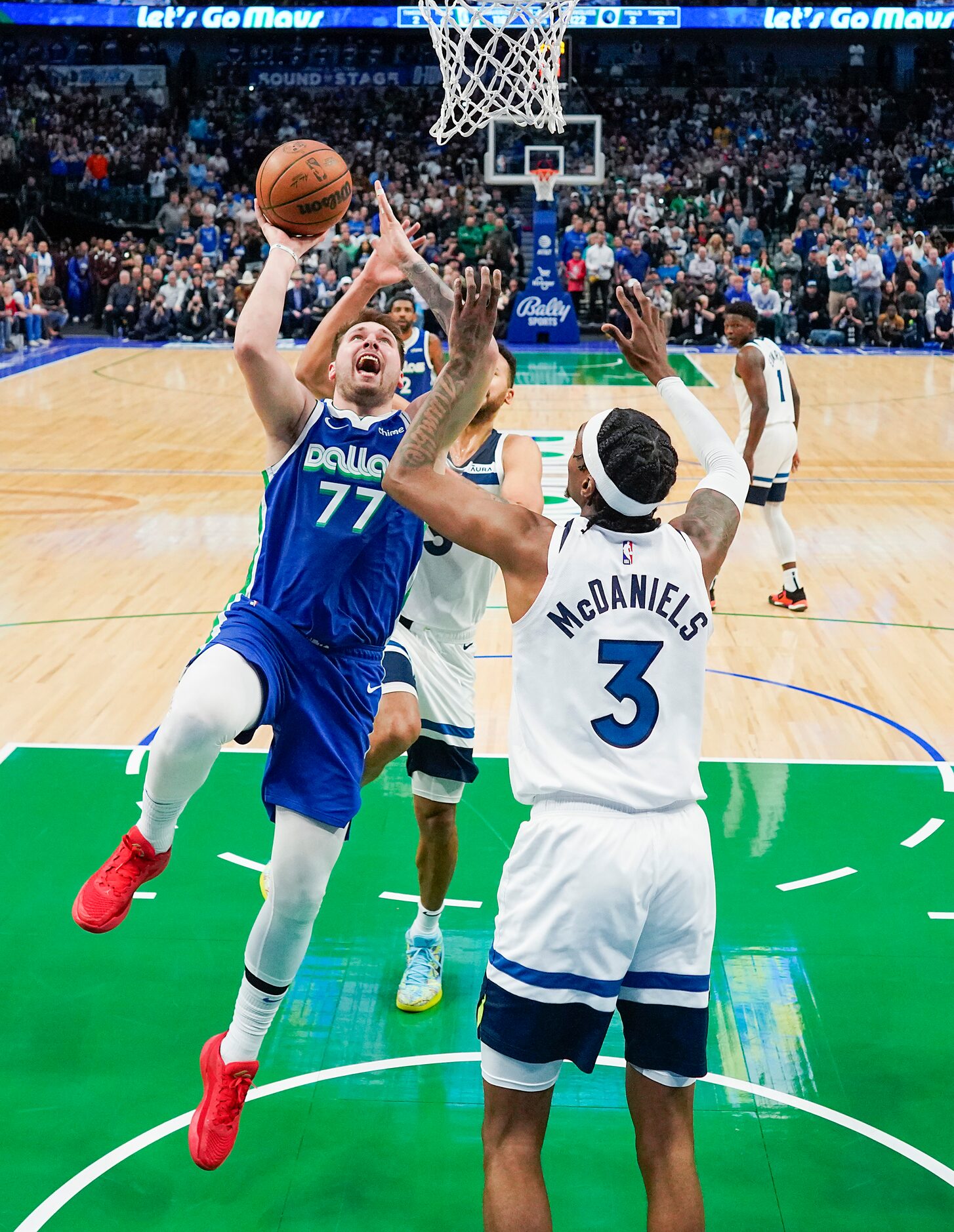 Dallas Mavericks guard Luka Doncic (77) puts up a shot over Minnesota Timberwolves forward...