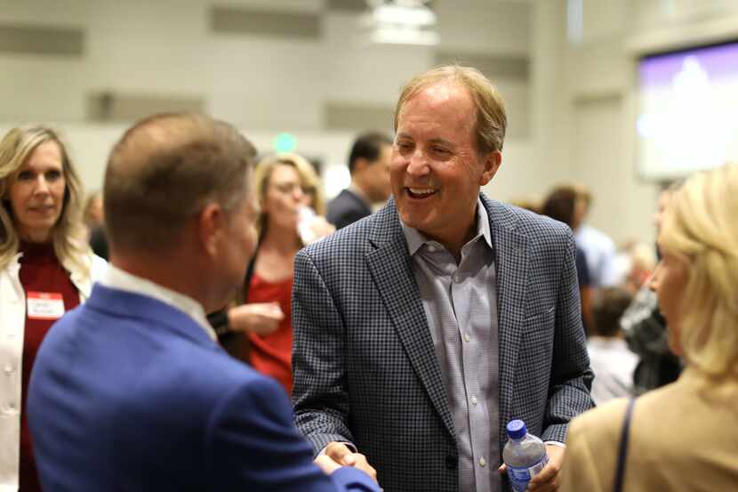 Daren Meis, left, meets with Ken Paxton during the GOP County Executive Meeting at the...