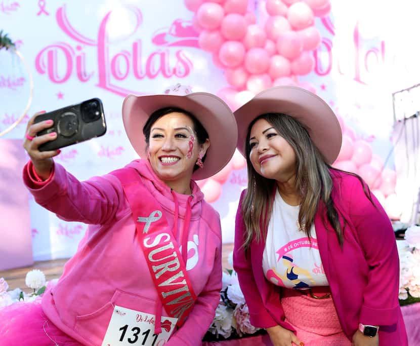 Lesly Cardona (left), and Anahy Chicas take a selfie during the Di'Lolas breast cancer...