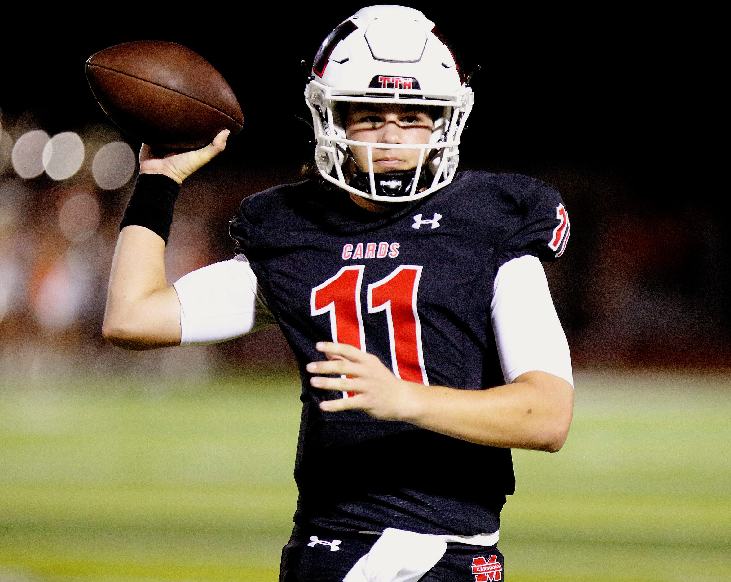 Melissa High School quarterback Sam Fennegan (11) throws a pass during the first half as...